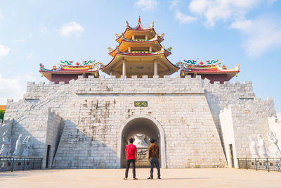 Men standing against temple in city