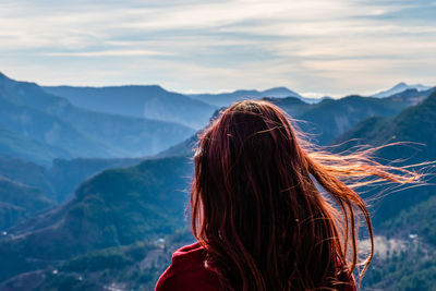 Rear view of woman against mountains