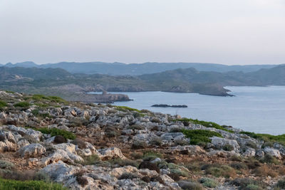 Scenic view of sea and mountains against sky