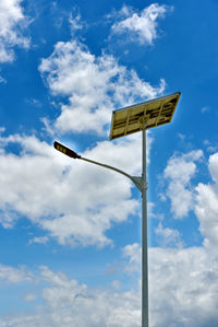 Low angle view of road sign against sky