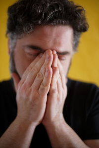 Close-up portrait of man covering face