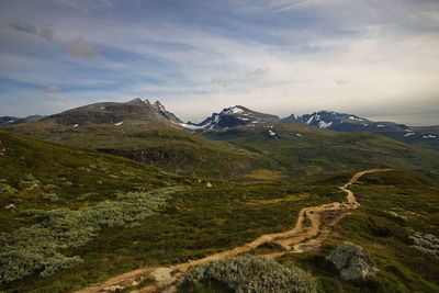 Scenic view of mountains against cloudy sky