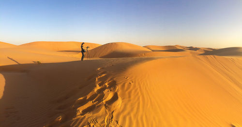 Scenic view of desert against clear sky