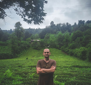 Portrait of young man standing on field