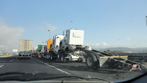 Cars on road against sky