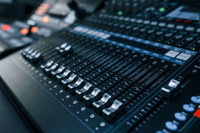 Close up view of radio mixing desk with professional sound equipment.