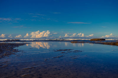 Scenic view of sea against blue sky