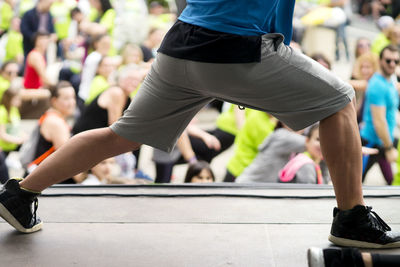 Low section of man running on footpath in marathon