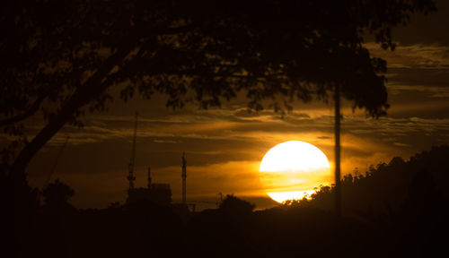 Silhouette trees against sky during sunset