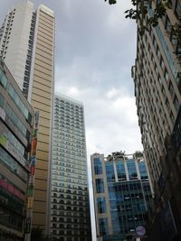 Low angle view of modern buildings in city against sky