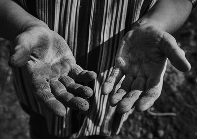 Midsection of man showing dirty hands