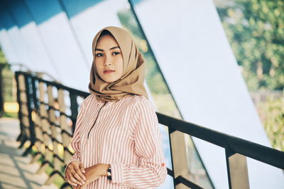 Portrait of young woman standing outdoors