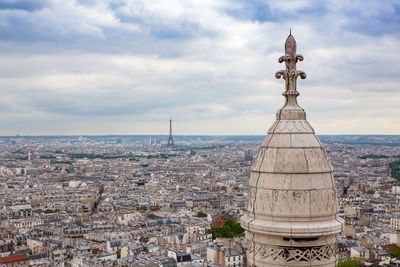 Cityscape against cloudy sky