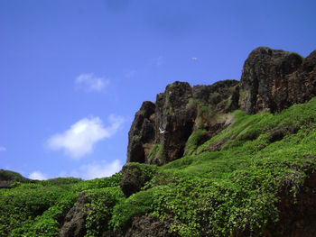 Low angle view of mountain against blue sky