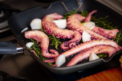 High angle view of meat in cooking pan on table