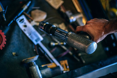 Cropped image of hands holding tool