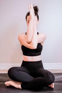 Low section of woman sitting at home