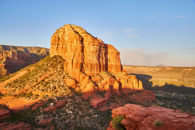 Rock formations on landscape against sky