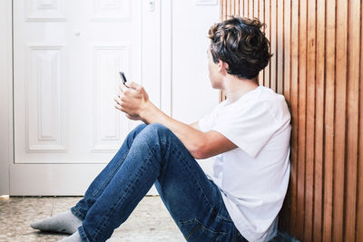 Side view of man using mobile phone