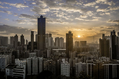 Skyscrapers in city during sunset