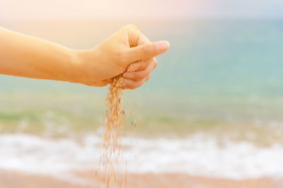 Cropped hand of woman holding water