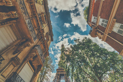 Low angle view of buildings against cloudy sky