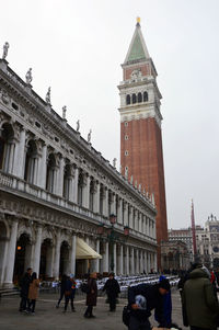 People in front of clock tower