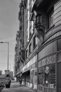 Low angle view of buildings by street against sky