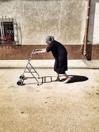 Full length of woman standing by railing