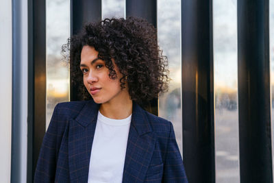 Portrait of woman looking through window