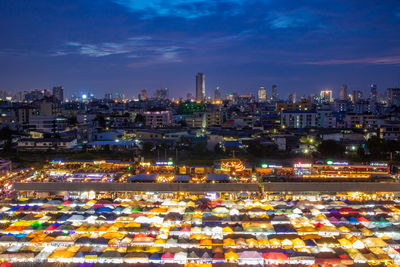 Aerial view of illuminated city buildings against sky