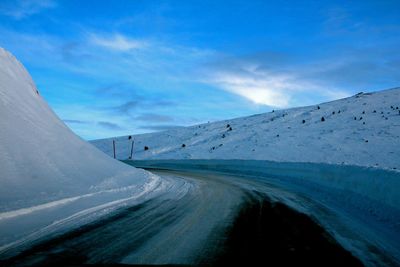 Snow covered road against clear sky