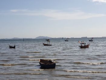 Boats in sea against sky