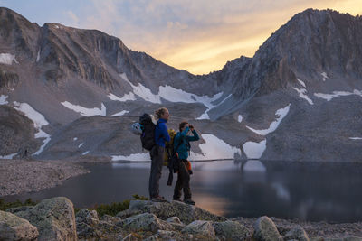 Women hikers watch sunset from pierre lakes, elk mountains, colorado