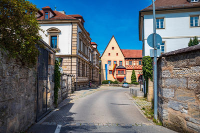 Street amidst buildings against sky