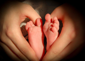 Close-up of hand holding baby feet