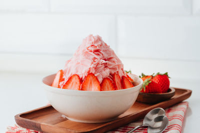 Close-up of chopped fruits in bowl on table