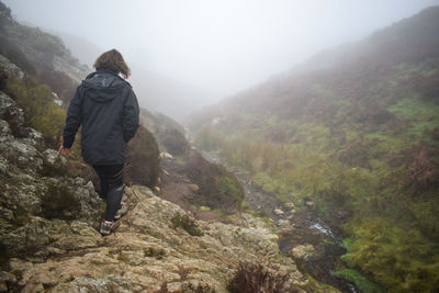 Rear view of woman looking at mountains