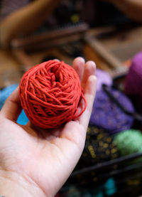 Cropped hand holding ball of wool