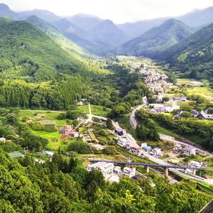 High angle view of trees and buildings against mountains