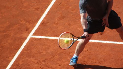 Low section of man playing tennis