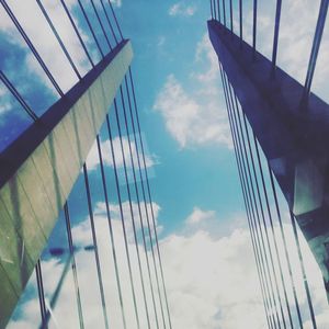 Low angle view of suspension bridge against sky