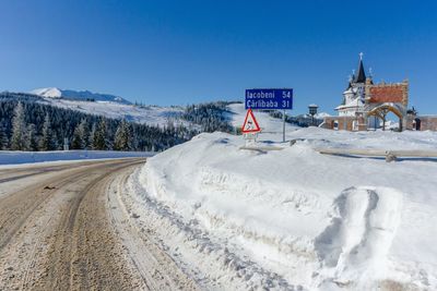 Snow covered landscape against clear sky