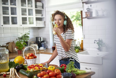 Young woman with vegetables at home