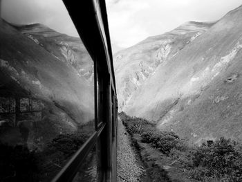 Reflection of mountains on train window