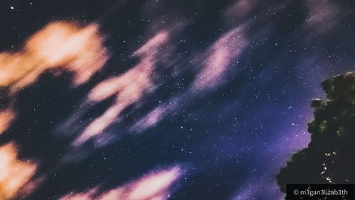 Low angle view of fireworks against sky at night