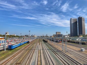 High angle view of railroad tracks by buildings against sky