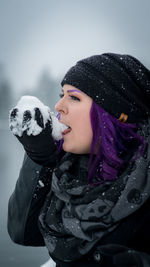 Portrait of young woman wearing hat during winter