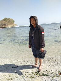 Full length of man standing on beach