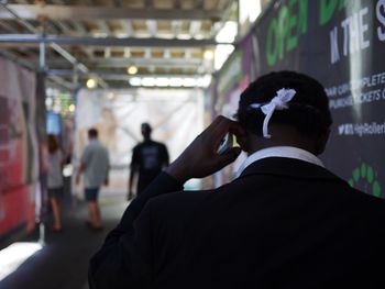 Rear view of man and woman using smart phone